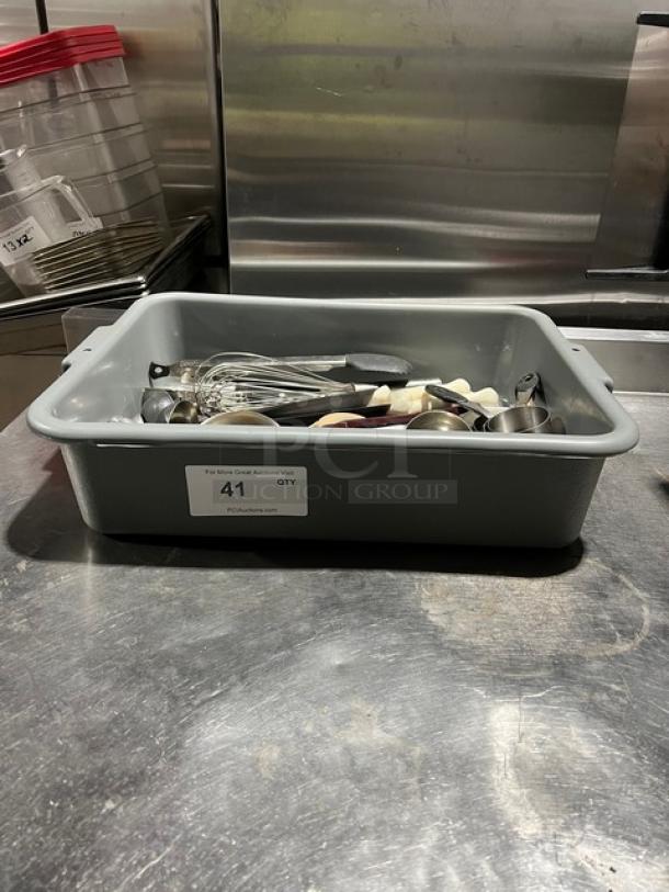 Gray bin with assorted kitchen utensils including whisks and spoons. Label reads "41 QTY." Used condition.