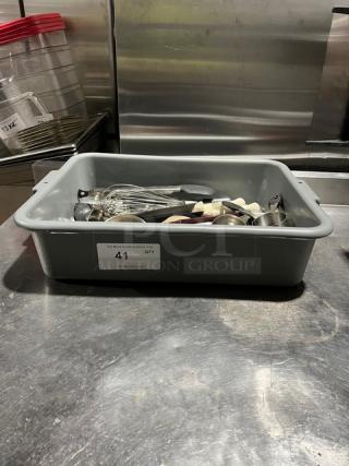 Gray bin with assorted kitchen utensils including whisks and spoons. Label reads "41 QTY." Used condition.