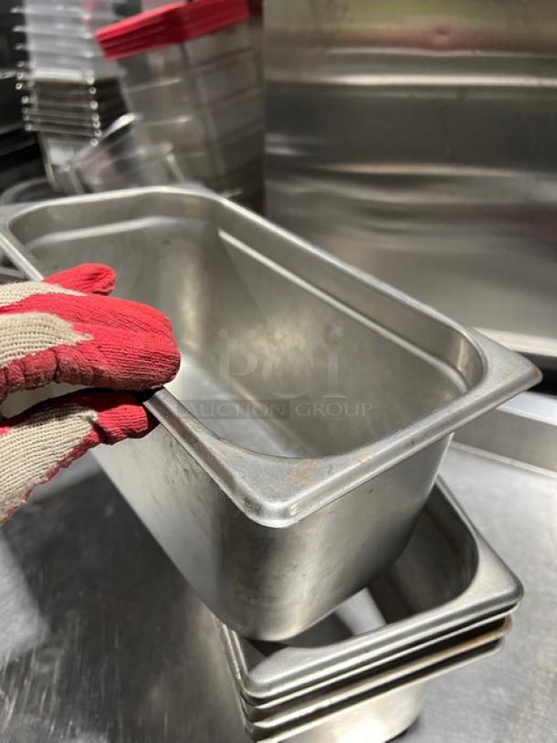 Winco SPJP306 stainless steel 1/3-size 6" deep steamtable pan in good condition, showing slight use marks.