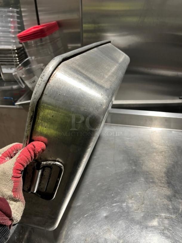 Commercial rectangular roasting pan with handles, metal finish, lightly used condition, sturdy design.