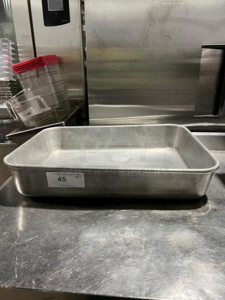 Commercial rectangular roasting pan with handles, metal, used condition. Features a label marked "45 QTY." Ideal for large batches.