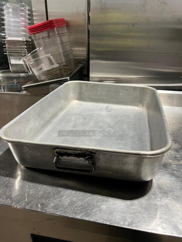 Commercial rectangular roasting pan with sturdy handles. Made of durable metal, lightly used, ideal for large-scale cooking.