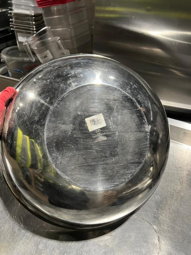 Vollrath stainless steel round mixing bowl, model 47949, shows usage with visible surface scratches. Manufacturer label visible.