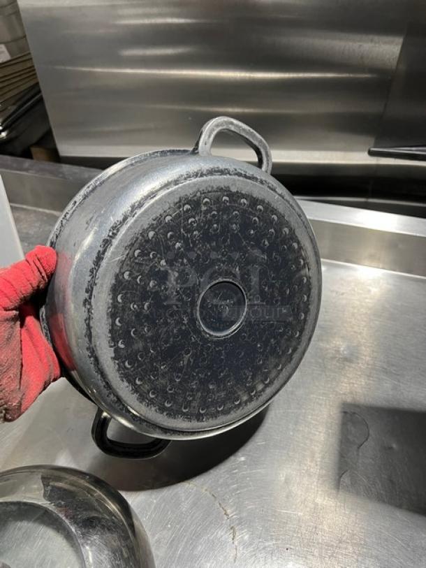 Commercial round braiser pan with dome lid, used condition. Visible wear on base, sturdy handles. Ideal for bulk cooking.
