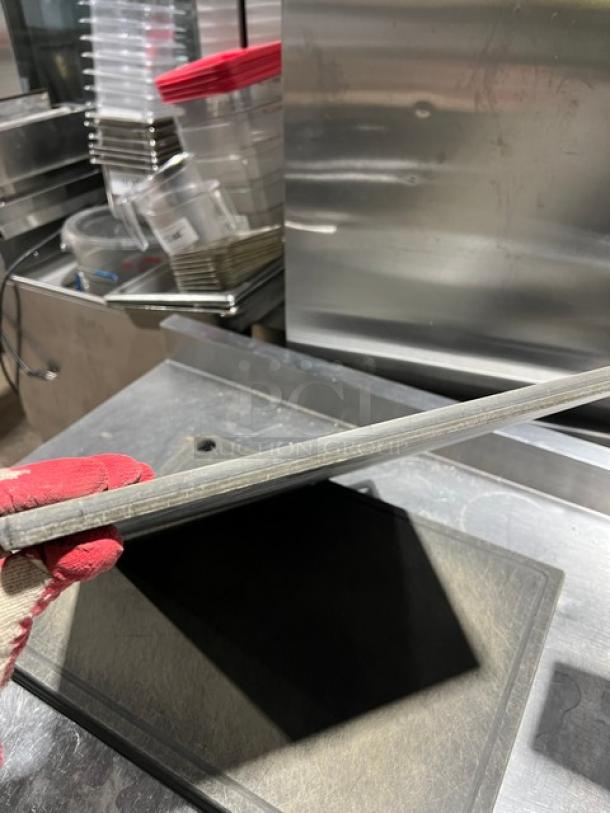 Rectangular commercial cutting board, slightly used, gray color, durable material, no visible markings, shown at an angle.