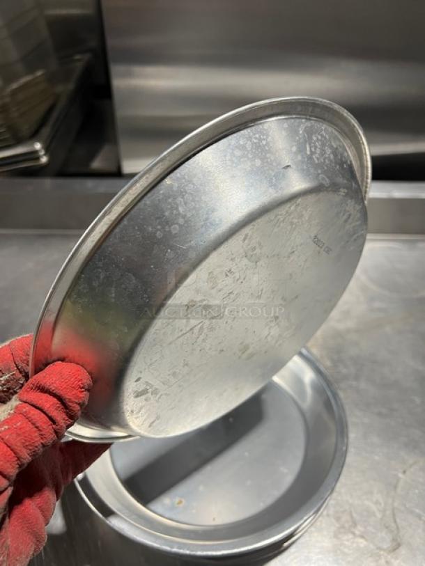 Commercial aluminum round pie pan, gently used, visible patina. Includes 15 pans per bid. Ideal for baking at scale.