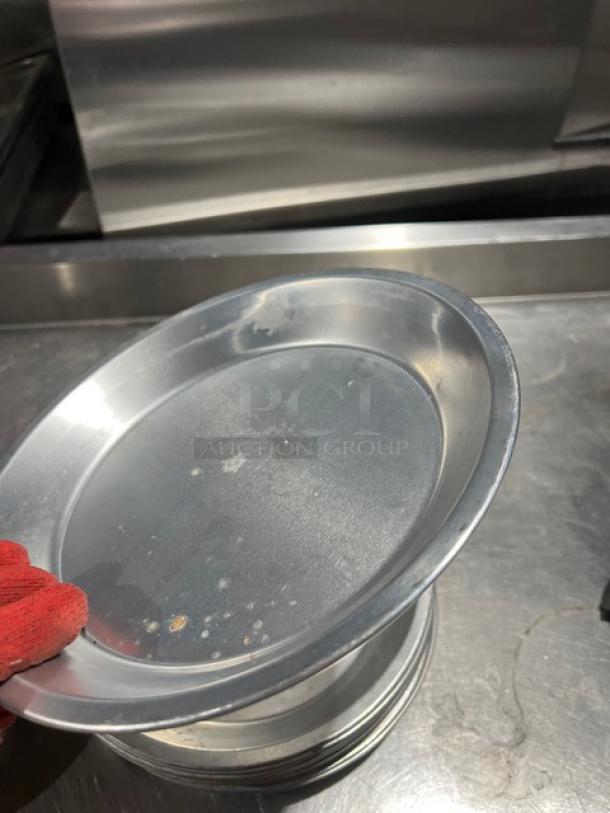 Commercial aluminum round pie pan, lightly used, showing minor surface marks. Size: approximately 15 inches. Ideal for baking.