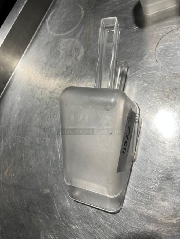Commercial clear handheld scoop, rectangular shape, sturdy plastic with handle. Marked "53X2" tag.