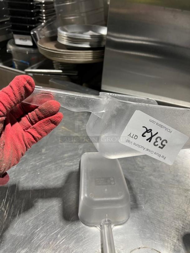 Clear handheld scoop with handle, auction lot tag "33X2". Slightly worn condition, ideal for commercial use.