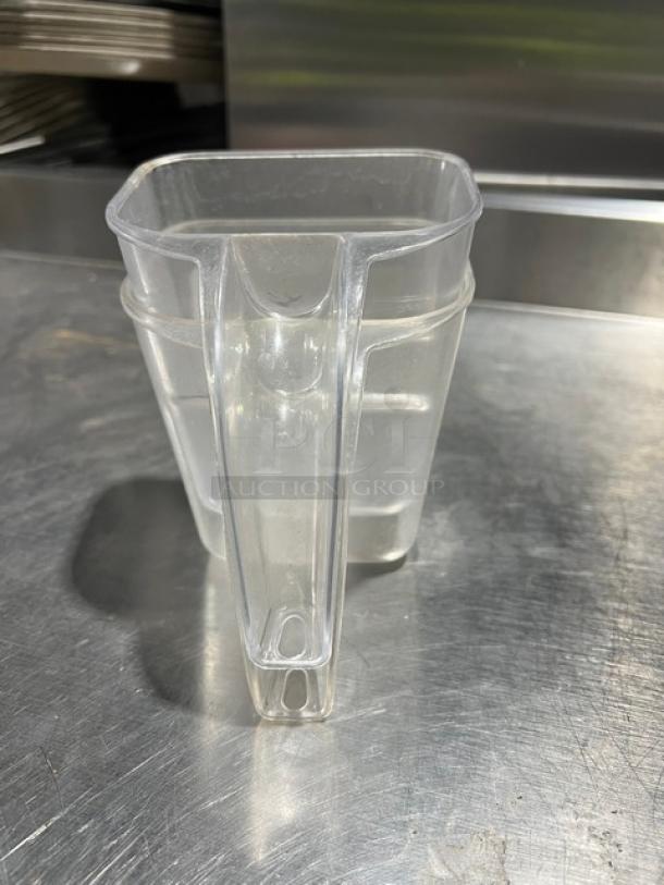 Clear 20 oz. handheld measuring cup, commercial-grade, plastic, rectangular shape, excellent condition, kitchen use.