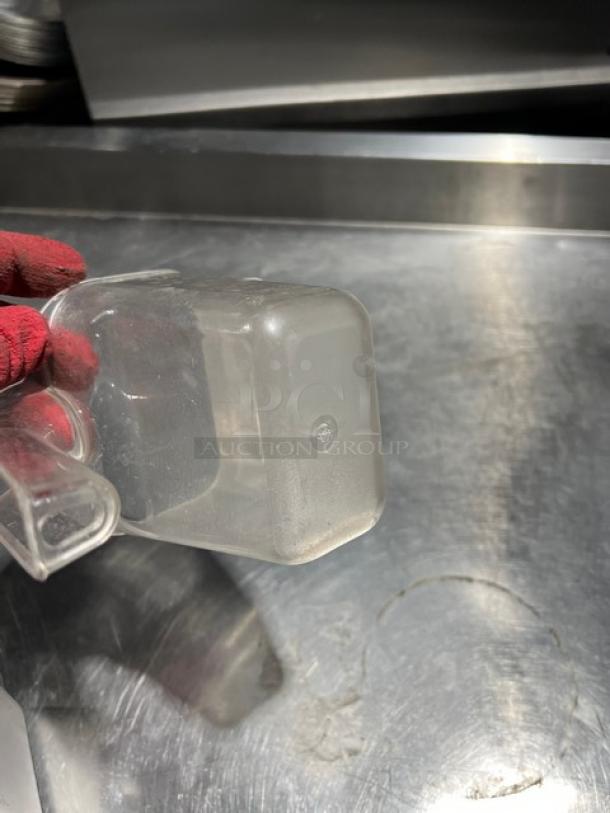 Commercial clear 20 oz. handheld measuring cup, good condition, lightweight, ergonomic handle, suitable for kitchen use.