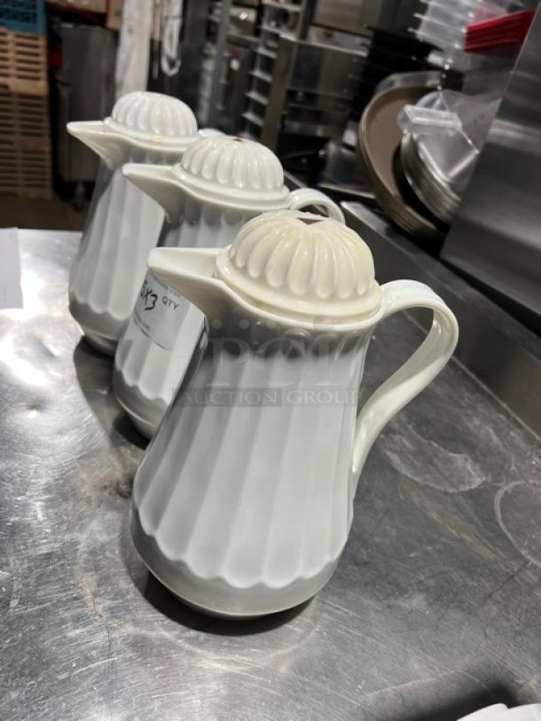 Commercial 42 oz. white swirl-design thermal coffee carafes, set of three, excellent condition, perfect for catering use.