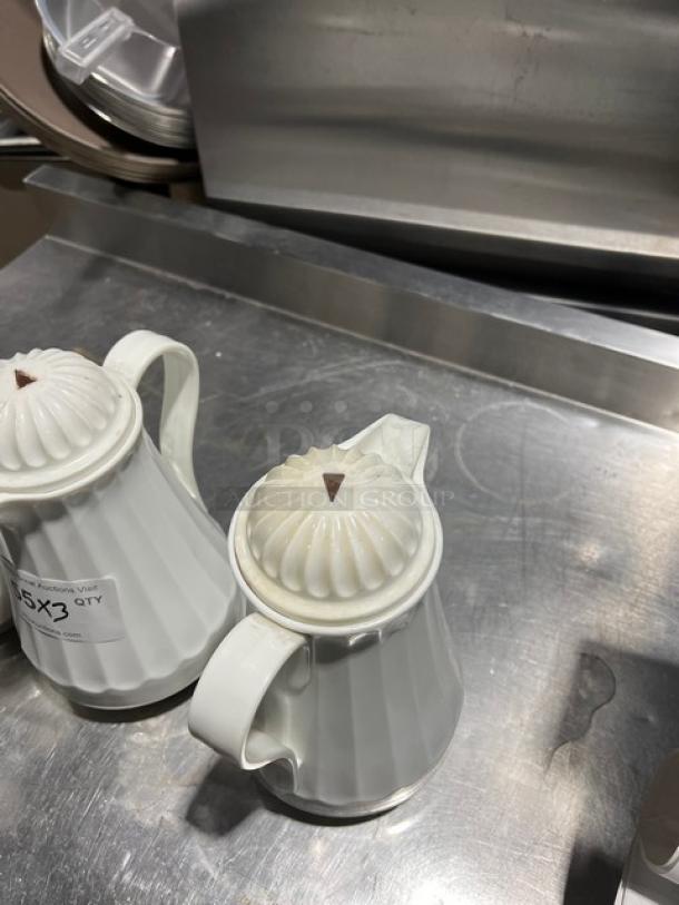 Commercial 42 oz thermal coffee carafe with white swirl design. Includes lid and handle. Auction label indicates 3X quantity.