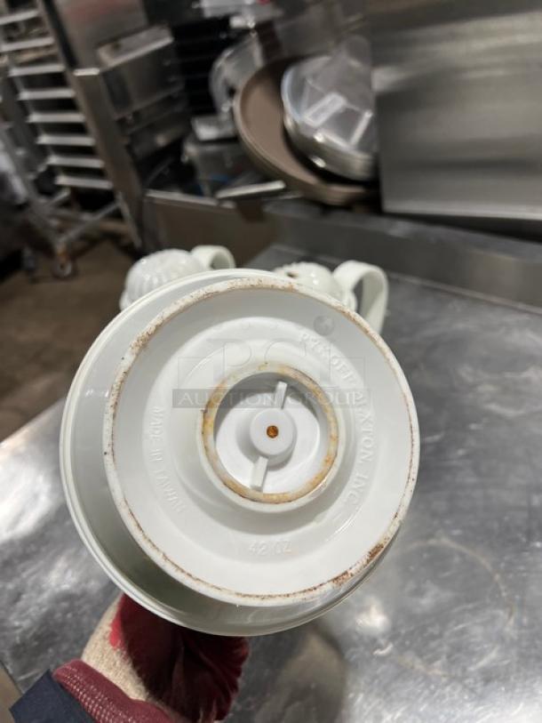 Commercial 42 oz. thermal coffee carafe with white swirl design. Visible signs of wear; bottom marked "Made in China."