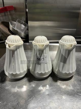 Three white swirl-design 42 oz. thermal coffee carafes in good condition, marked for auction.