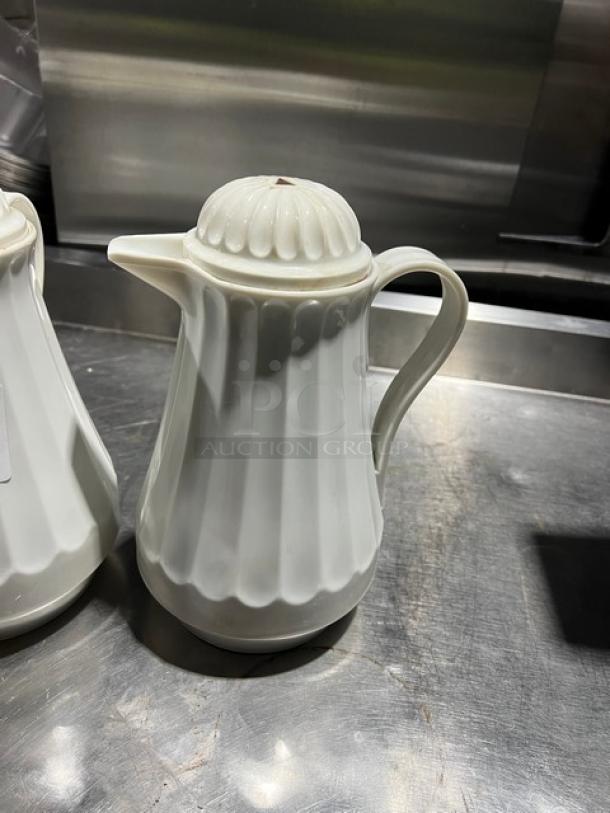 Commercial 42 oz. thermal coffee carafe with white swirl design, excellent condition, elegant handle and spout.