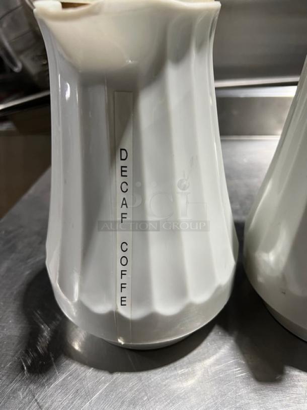 Commercial white swirl-design thermal coffee carafe, 42 oz, labeled "Decaf Coffee," in good condition.