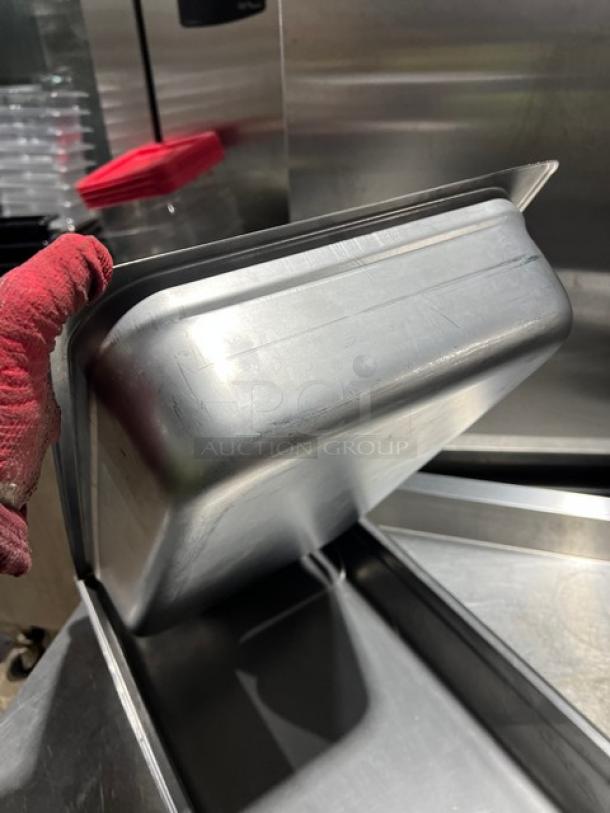 Winco stainless steel full-size 4" deep anti-jam hotel pan, model SPJL-104, used condition, slight surface wear.