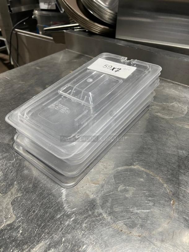 Clear polycarbonate food pan lid with notch and handle, stack of seven, in excellent condition, item tag visible.
