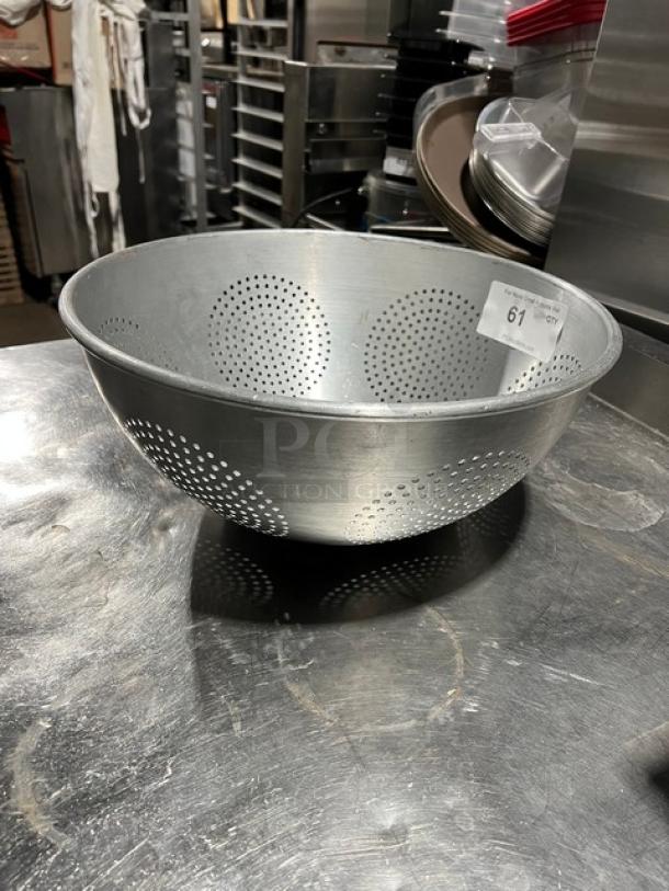 Commercial aluminum round colander with geometric perforations, excellent condition, auction tag 61 visible.
