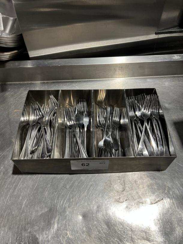 Lot of commercial forks in a 4-compartment metal organizer, used condition. Label on organizer: "62 QTY."