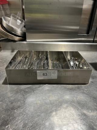Lot of commercial miscellaneous knives and spoons in 4-compartment stainless steel organizer. Label reads "63 QTY, PCIauction.com".