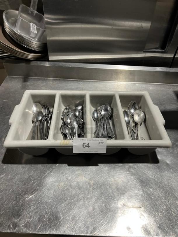 Lot of miscellaneous commercial spoons in a 4-compartment utensil organizer, used condition. Auction tag reads "64 QTY."