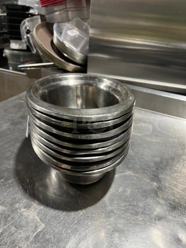 Commercial stainless steel oval food pans stacked, polished finish, excellent condition, 8 pans included, durable and versatile.