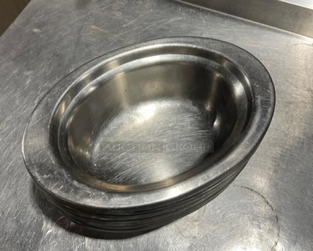 Commercial stainless steel oval food pan, durable, polished finish, stackable design, used condition.