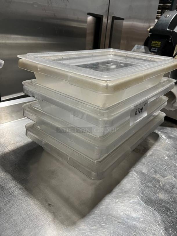 Carlisle StorPlus 2-Gal clear polycarbonate food storage containers with lids, stacked, commercial kitchen setting.