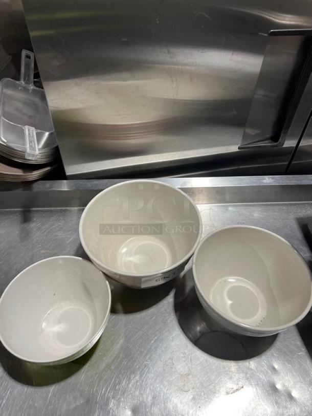 Set of three commercial round bowls in assorted sizes, white, in good condition, placed on a metal countertop.