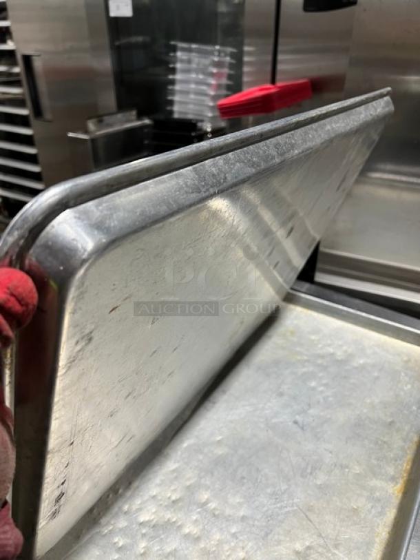 Commercial stainless steel full-size sheet pan in used condition, showing minor wear. Durable and ideal for high-volume use.