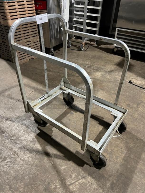 New Age Industries heavy-duty sheet pan dolly on casters, metal frame, used condition, suitable for commercial kitchens.