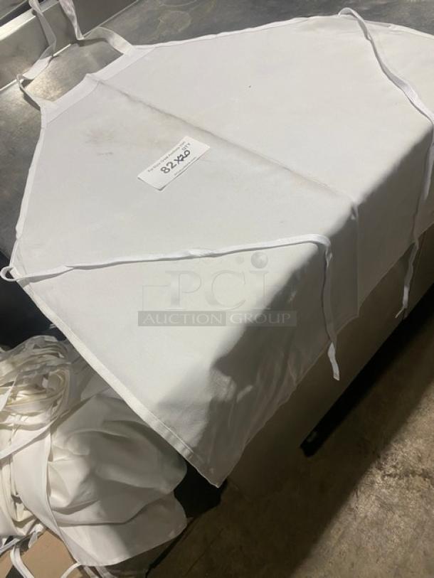 Commercial white full-length bib apron, slightly soiled, dimensions 32"x28", multiple available.