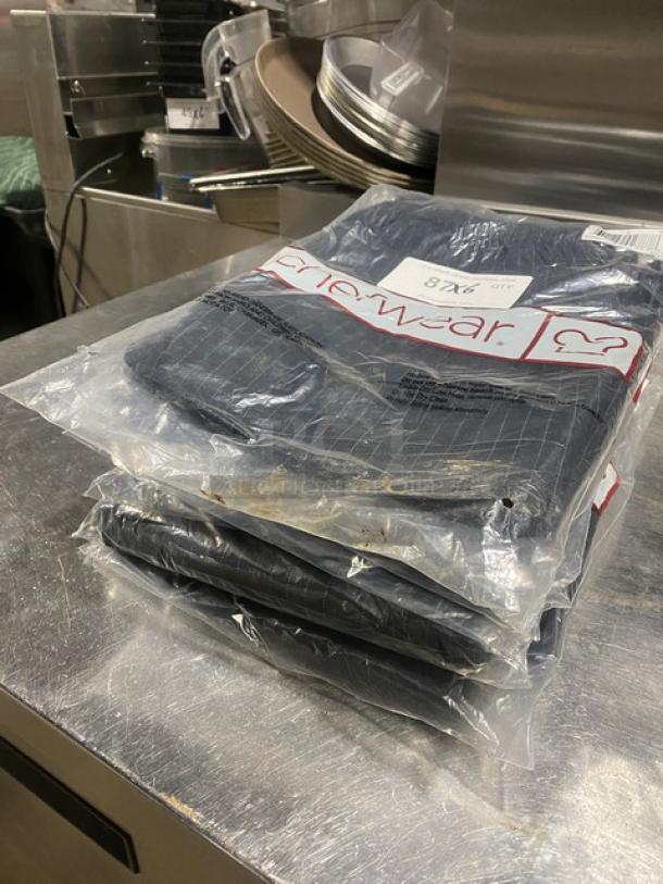 New Chefwear CW3100-CW50 black medium chef pants in packaging. Includes size label; ideal for commercial kitchens.