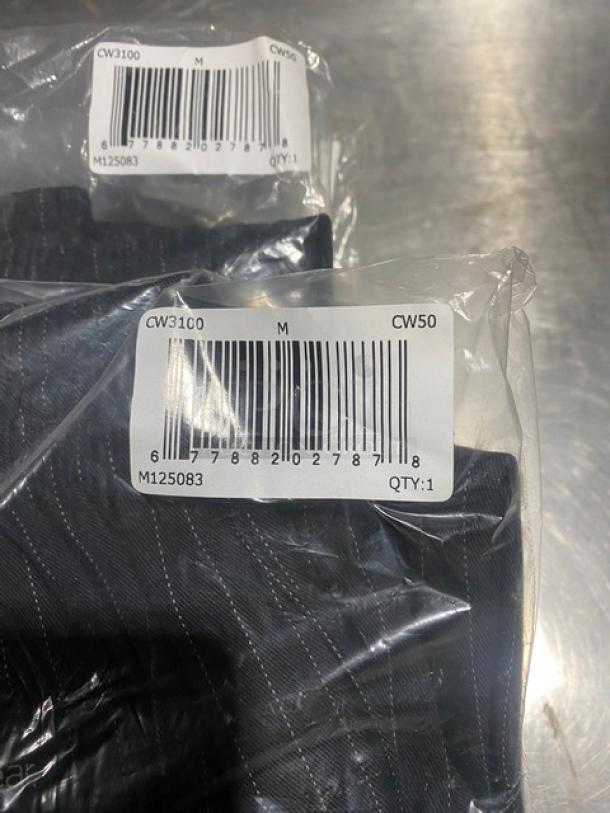 Chefwear CW3100CW50 black medium chef pants, new in packaging with barcode label displaying model and size information.
