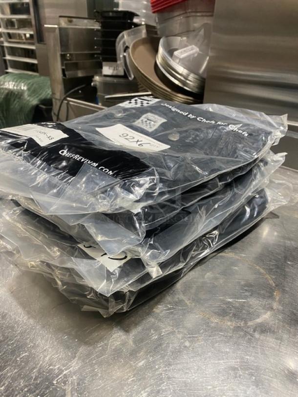 New Chef Revival black cargo chef pants, XS size, model P024BKXS, packaged, polyester/cotton blend, stack of six.