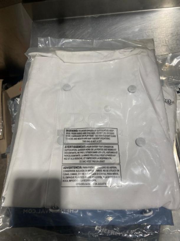 Chef Revival J006S commercial white chef coat, size S, new in packaging with buttons and care label visible.