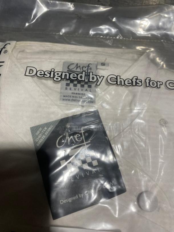 "New Chef Revival J006S white small chef coat, packaged. Tags show brand, model, size. Crisp condition, great for chefs."