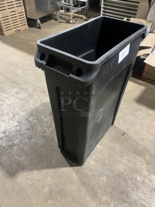 Rubbermaid Slim Jim black rectangular 23-gallon trash can, commercial-grade, used condition, with integrated handles.