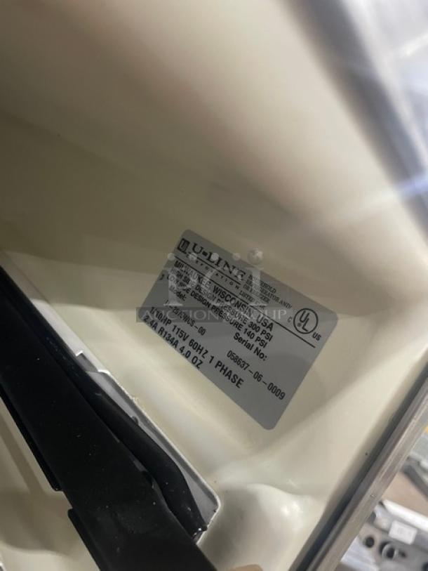 U-Line U-2075WCS-00 stainless steel merchandiser; model tag shows 115V 1 Phase, SN 058637-06-0009, Made in USA.