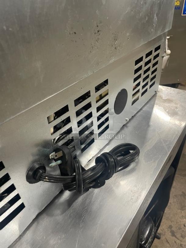 U-Line stainless steel wine merchandiser, model U-2075WCS-00. Features single glass door, 115V 1 phase. Visible power cord.