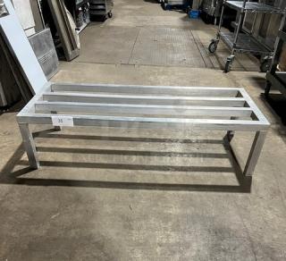 Commercial aluminum heavy-duty dunnage rack on legs, sturdy construction, good condition, numbered tag 35 visible.
