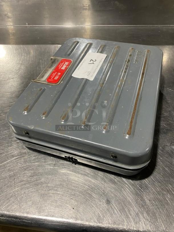 Rubbermaid Peluoze Model FG4100UD briefcase-style 100 lb. analog shipping scale in good condition, visible labels on top.