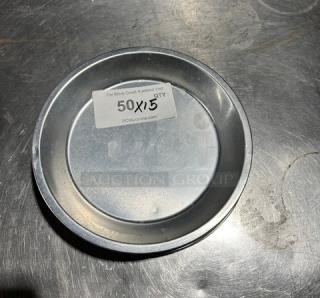 Commercial aluminum round pie pan, visibly labeled "50X5 QTY," in good condition on a metal surface.
