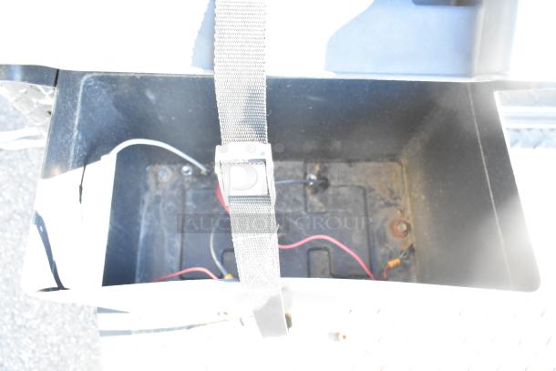 Battery compartment of Southern Dimensions Shell Food Trailer with securing strap and visible wiring, ready for outfitting.