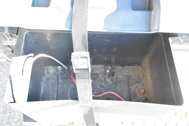 Auction image showing interior of a storage compartment in the Southern Dimensions Shell Food Trailer, with wiring and a retaining strap visible.