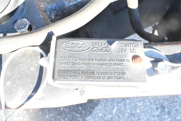 ESCO breakaway switch labeled for 12V DC. Caution and warning text advise on brake plunger removal risks.