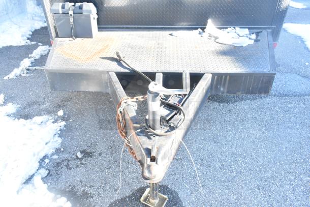 Southern Dimensions Shell Food Trailer hitch view on a snowy surface. Ready for outfitting, includes a Kenmore chest freezer.