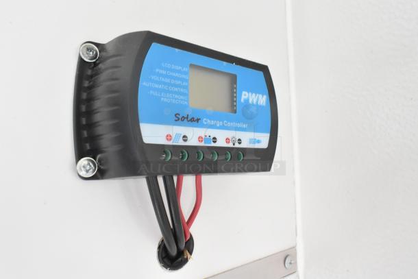 PWM solar charge controller in the Southern Dimensions Shell Food Trailer, featuring LCD display and wiring connections.